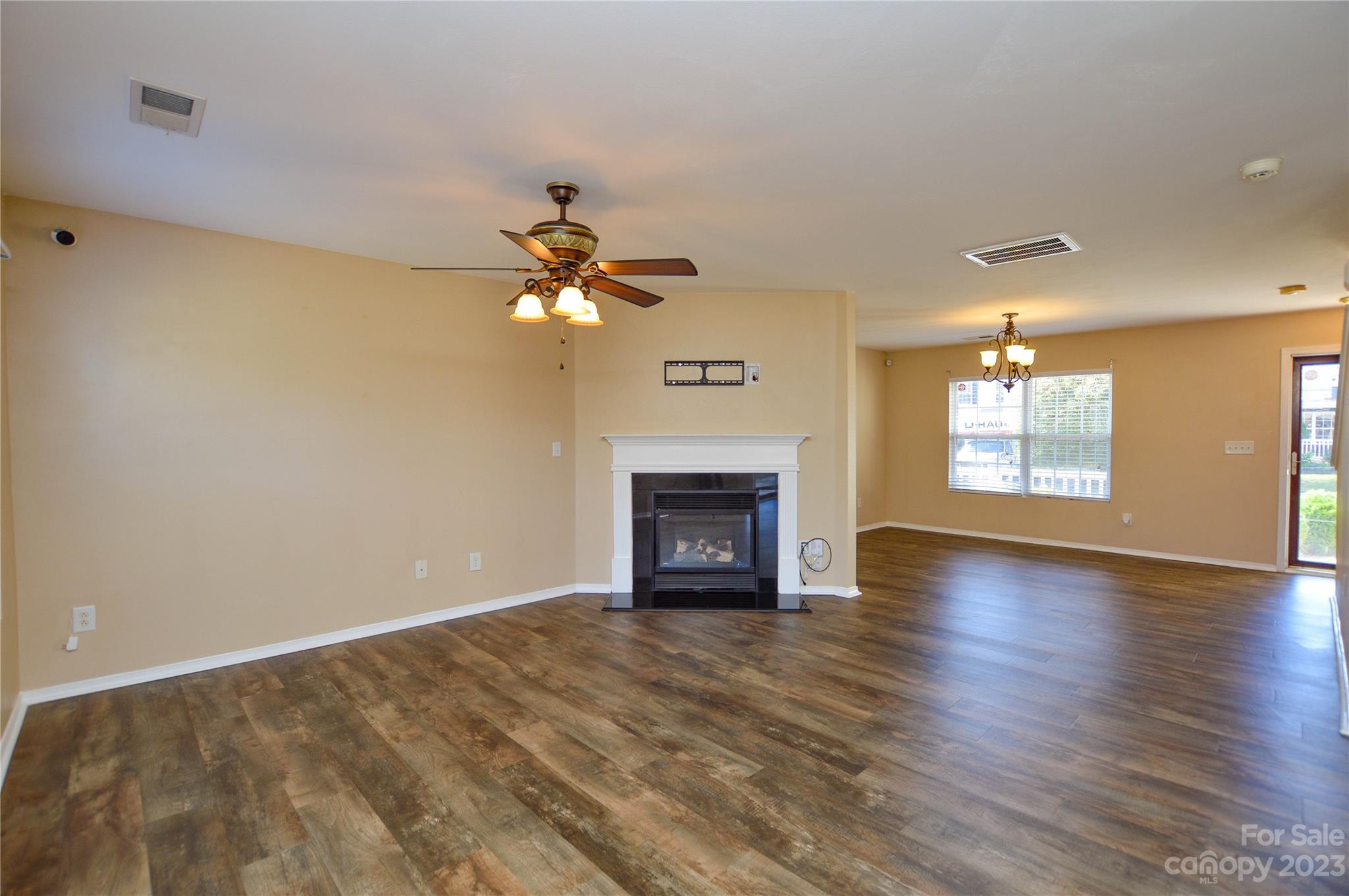 9310 John Russell Road Charlotte, NC 28215 - Photo 14 of 40 a view of an empty room with a fireplace and a window