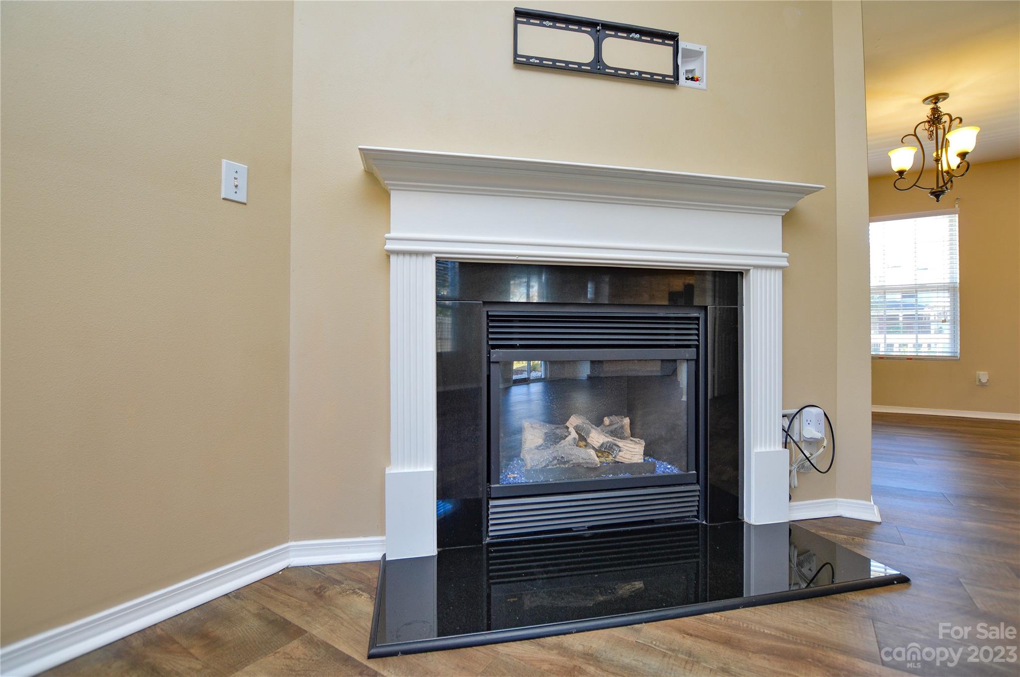 9310 John Russell Road Charlotte, NC 28215 - Photo 15 of 40 a living room with a fireplace and a wooden floor