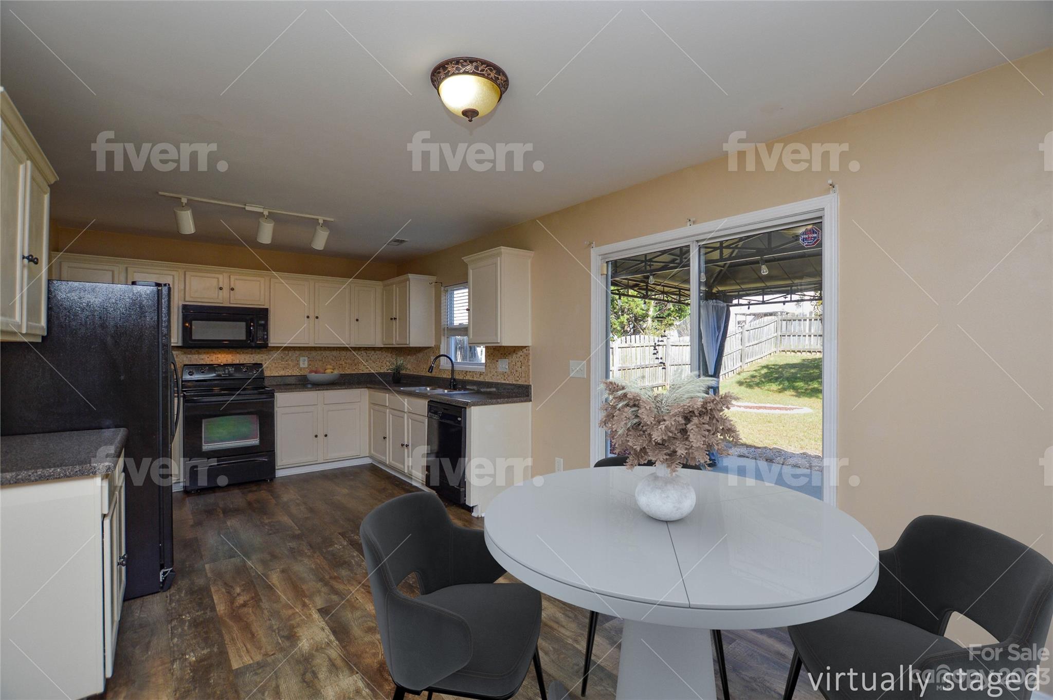 9310 John Russell Road Charlotte, NC 28215 - Photo 16 of 40 a kitchen with kitchen island a stove a table and chairs