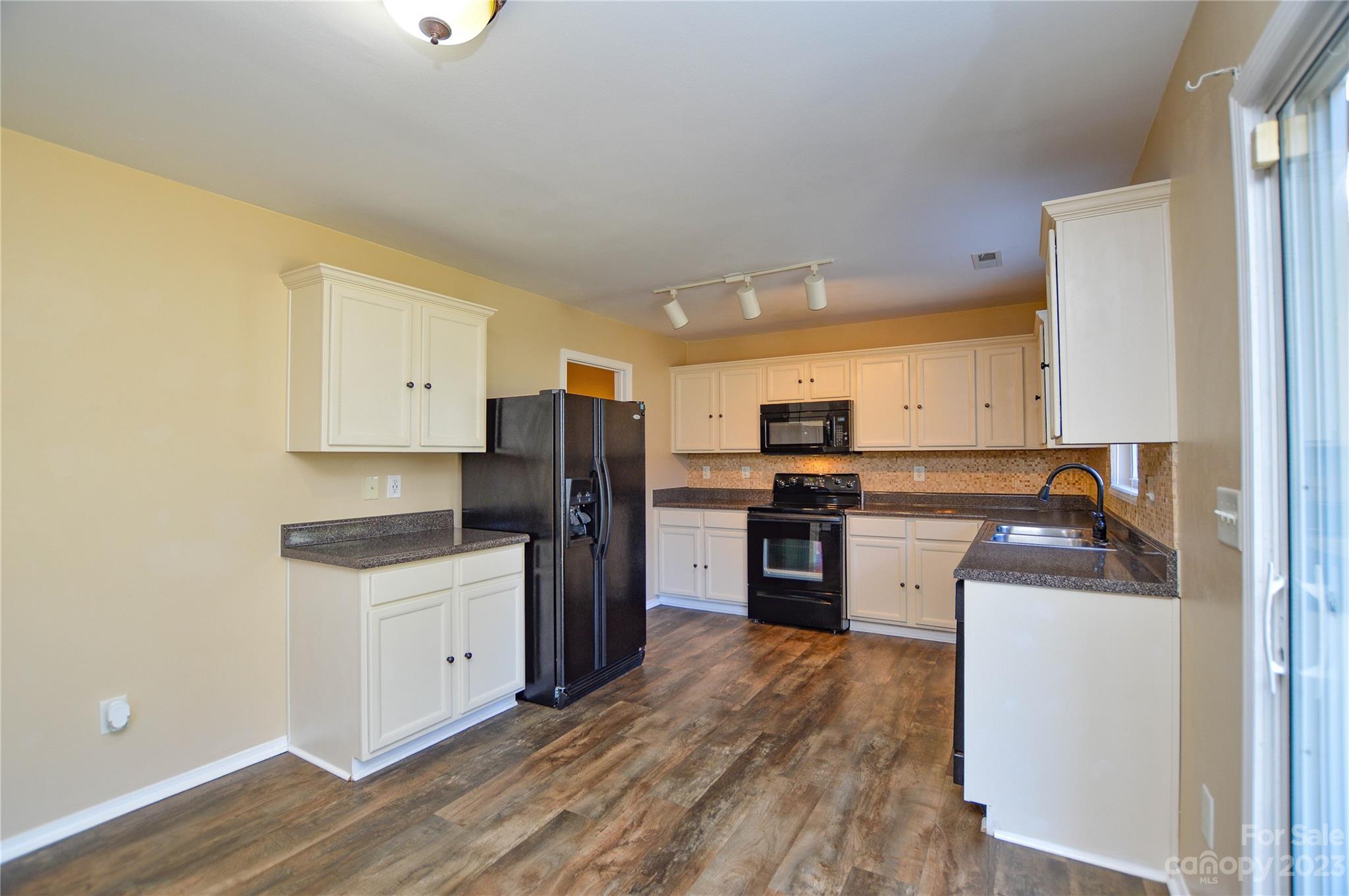 9310 John Russell Road Charlotte, NC 28215 - Photo 19 of 40 a kitchen with a refrigerator sink and stove top oven