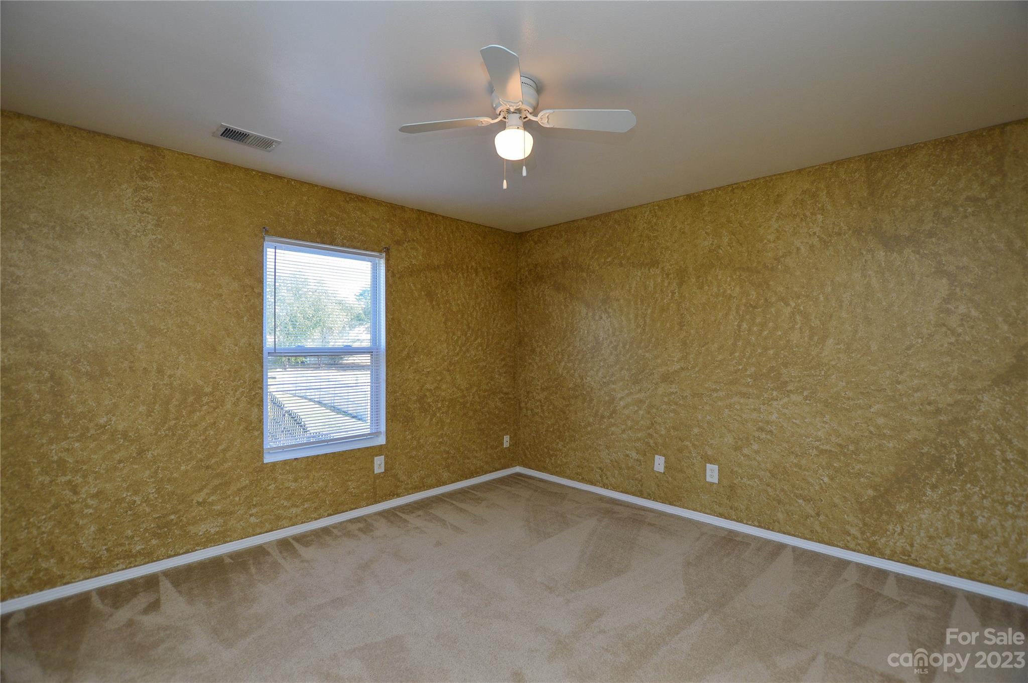 9310 John Russell Road Charlotte, NC 28215 - Photo 24 of 40 an empty room with windows and ceiling fan