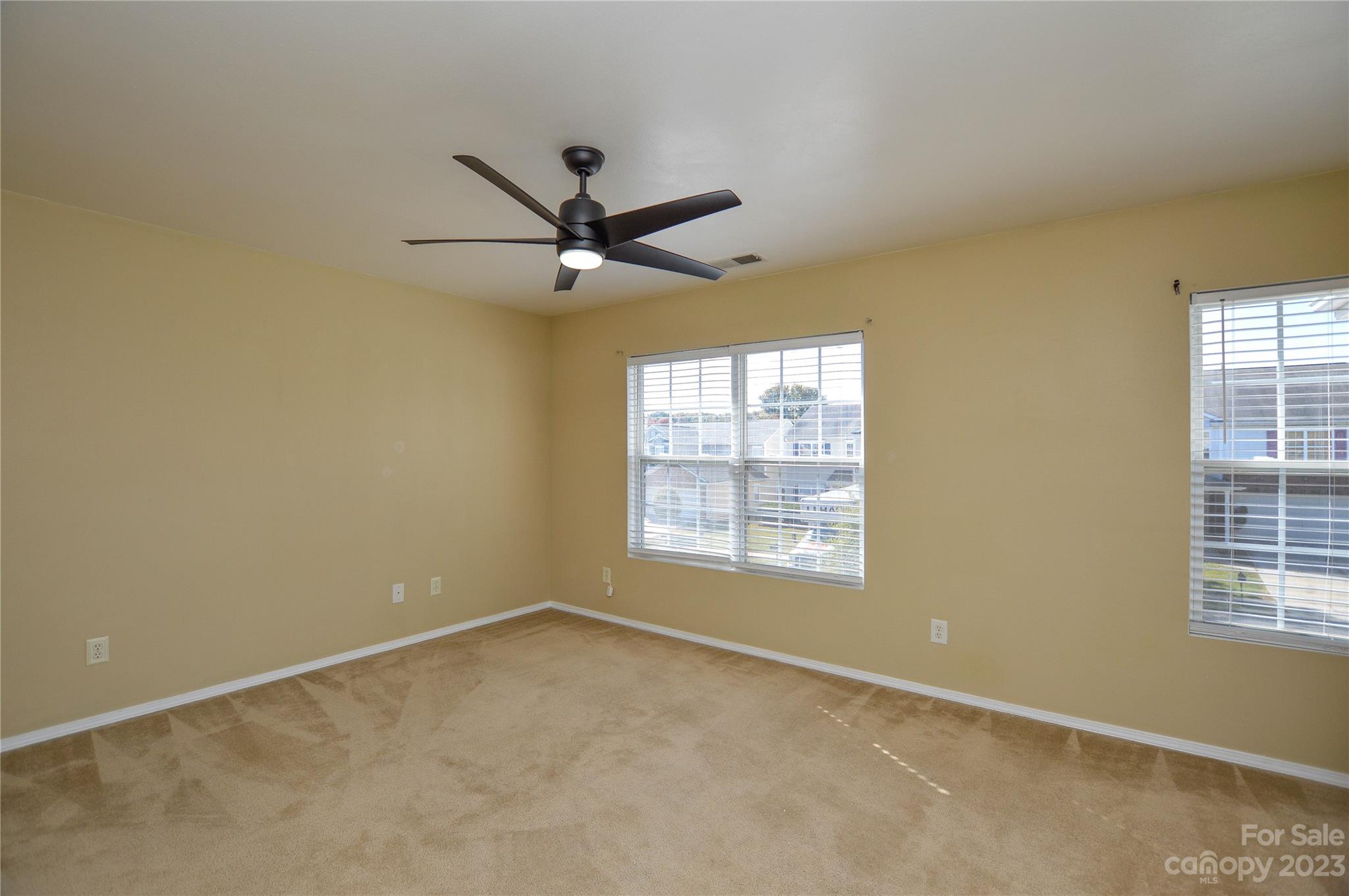9310 John Russell Road Charlotte, NC 28215 - Photo 26 of 40 an empty room with a window and a fan
