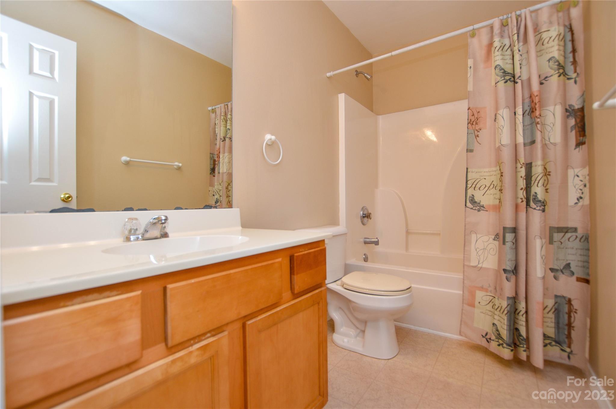 9310 John Russell Road Charlotte, NC 28215 - Photo 27 of 40 a bathroom with a sink a toilet and shower