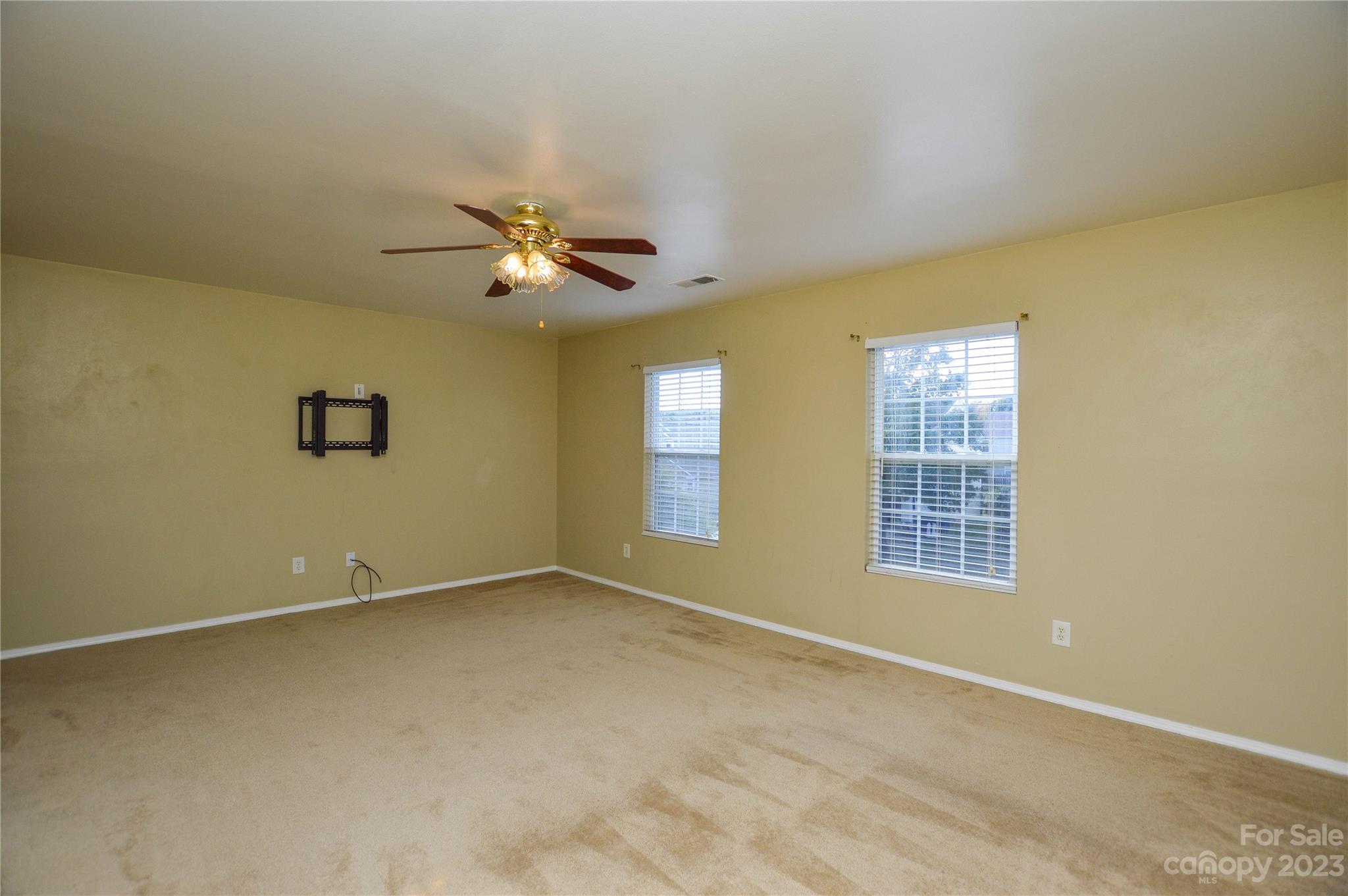 9310 John Russell Road Charlotte, NC 28215 - Photo 33 of 40 an empty room with windows and ceiling fan