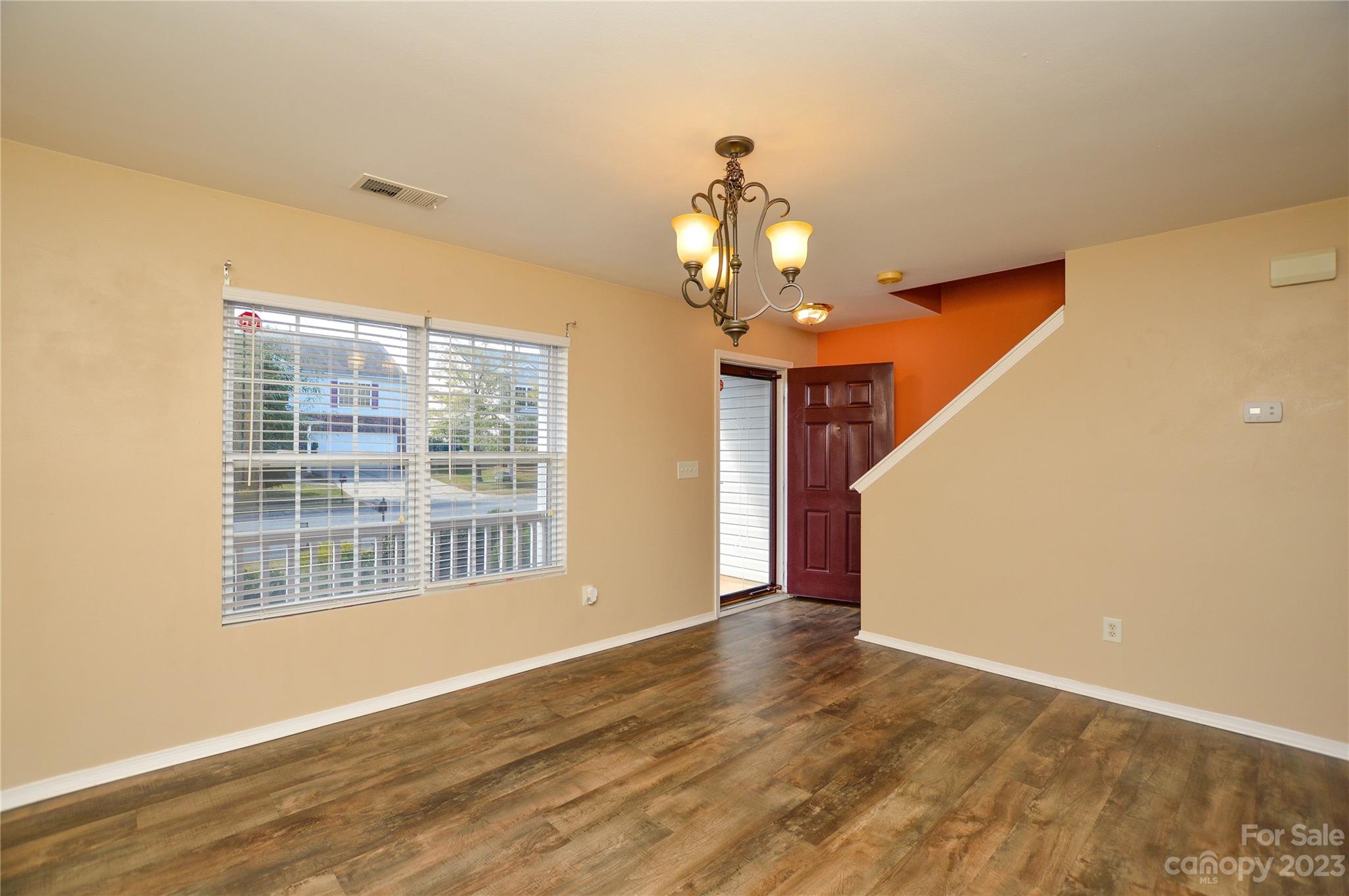 9310 John Russell Road Charlotte, NC 28215 - Photo 8 of 40 a view of livingroom with chandelier fan and wooden floor