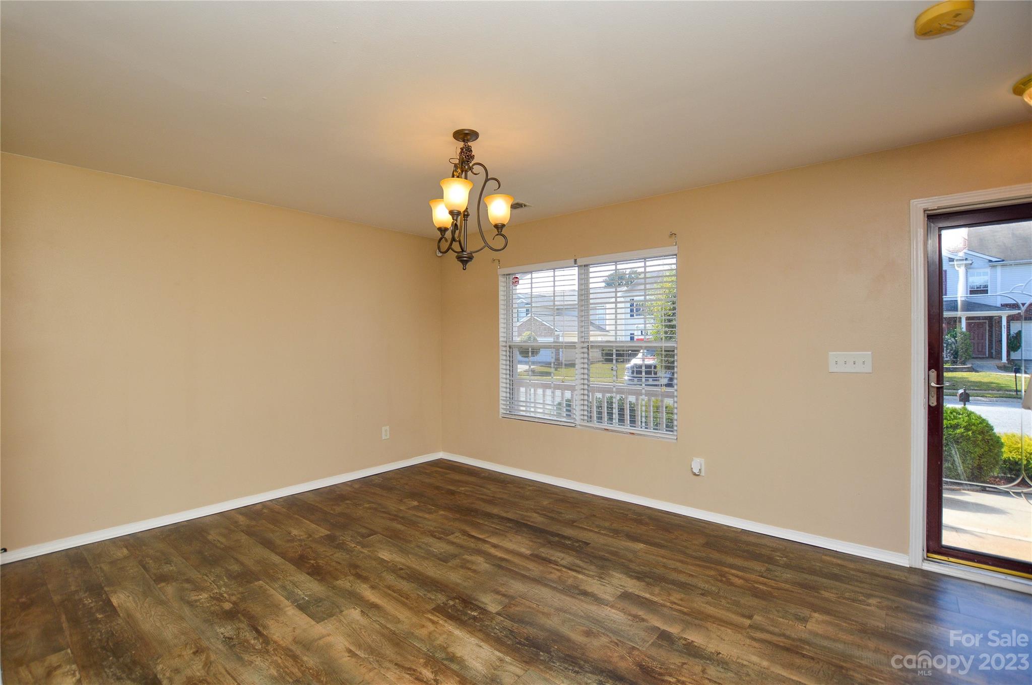 9310 John Russell Road Charlotte, NC 28215 - Photo 10 of 40 a view of empty room with wooden floor and fan