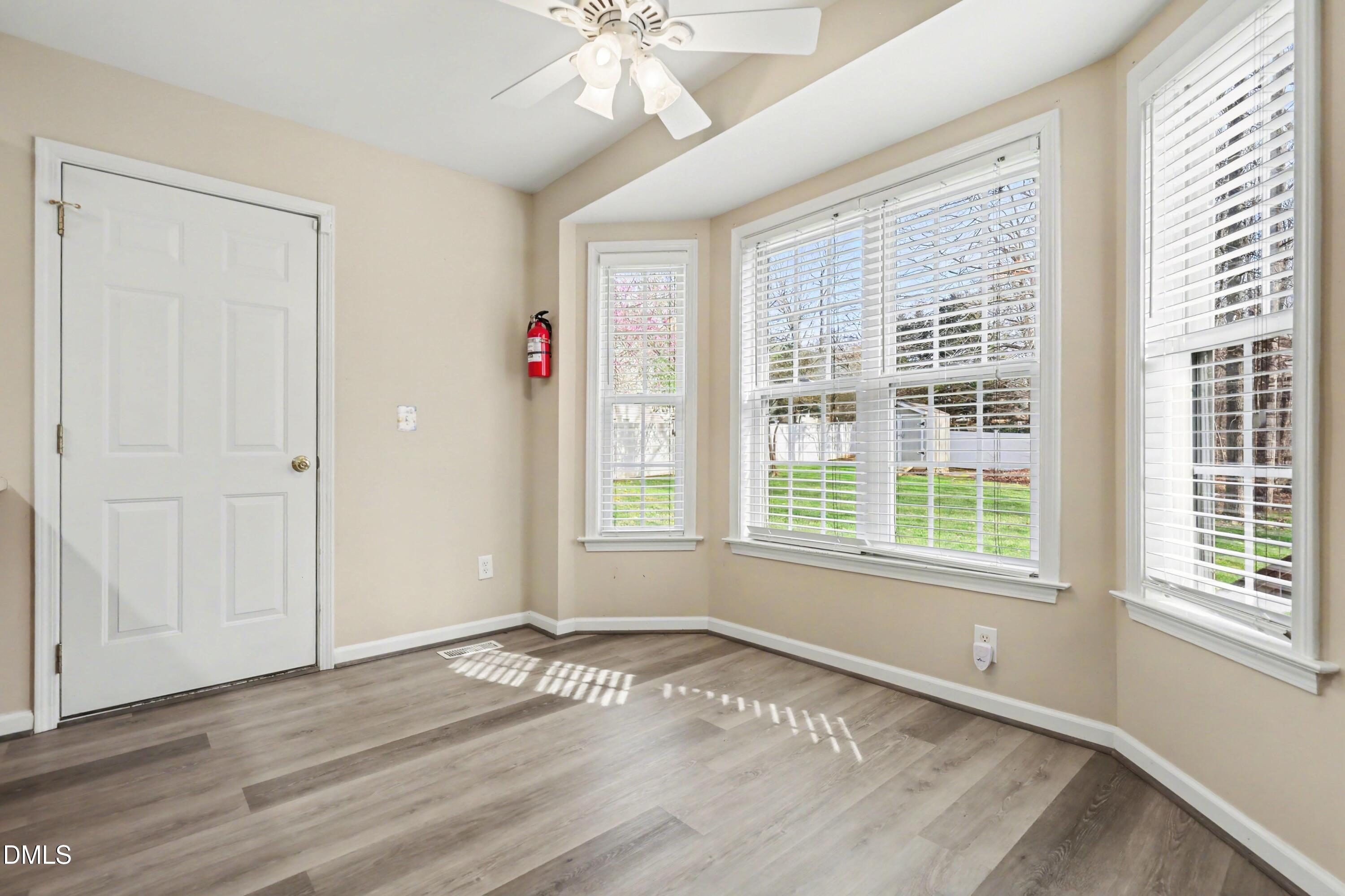 390 Eagle Stone Ridge Youngsville, NC 27596 - Photo 12 of 29 a view of an empty room with wooden floor and a window