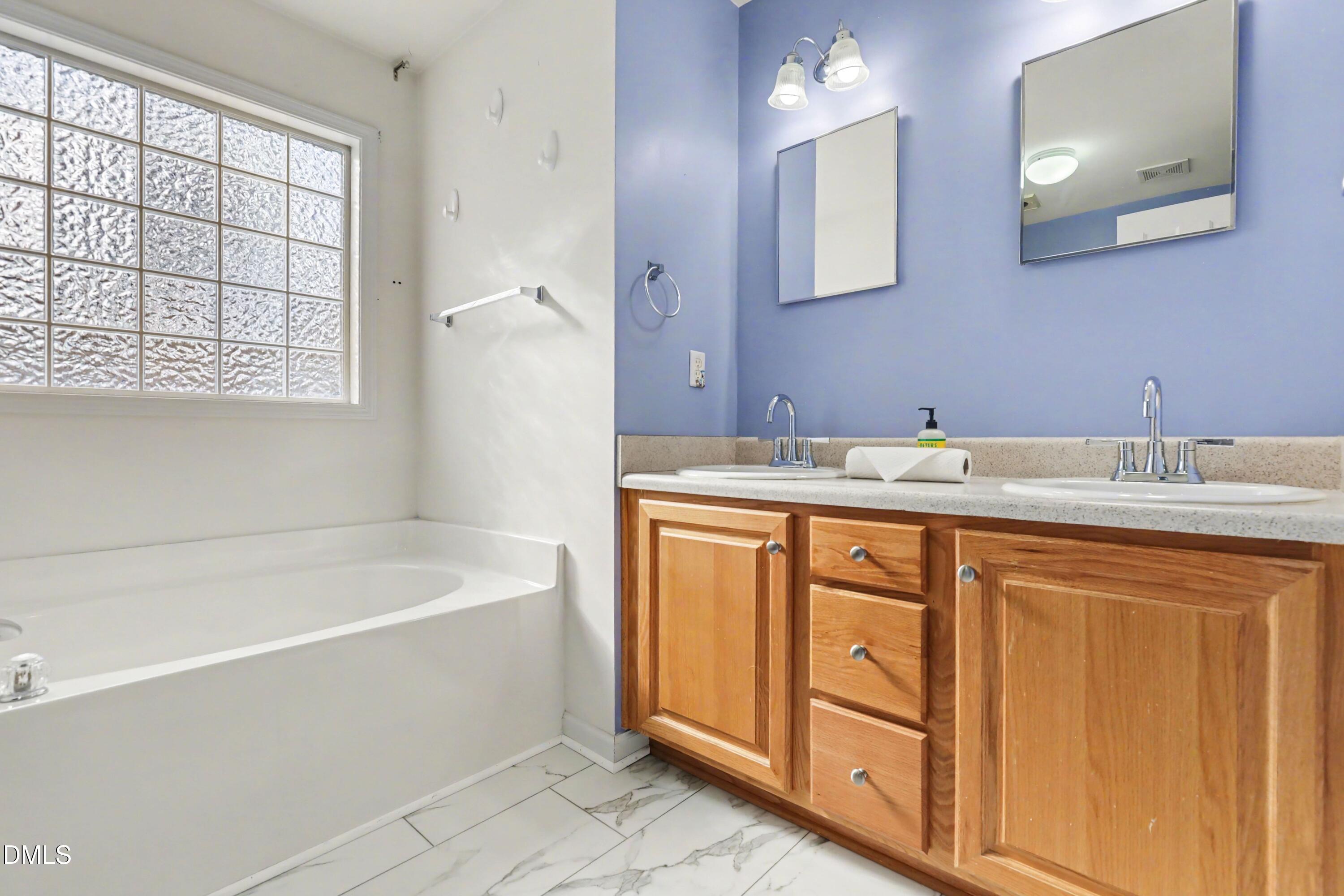 390 Eagle Stone Ridge Youngsville, NC 27596 - Photo 17 of 29 a spacious bathroom with a tub sink and mirror