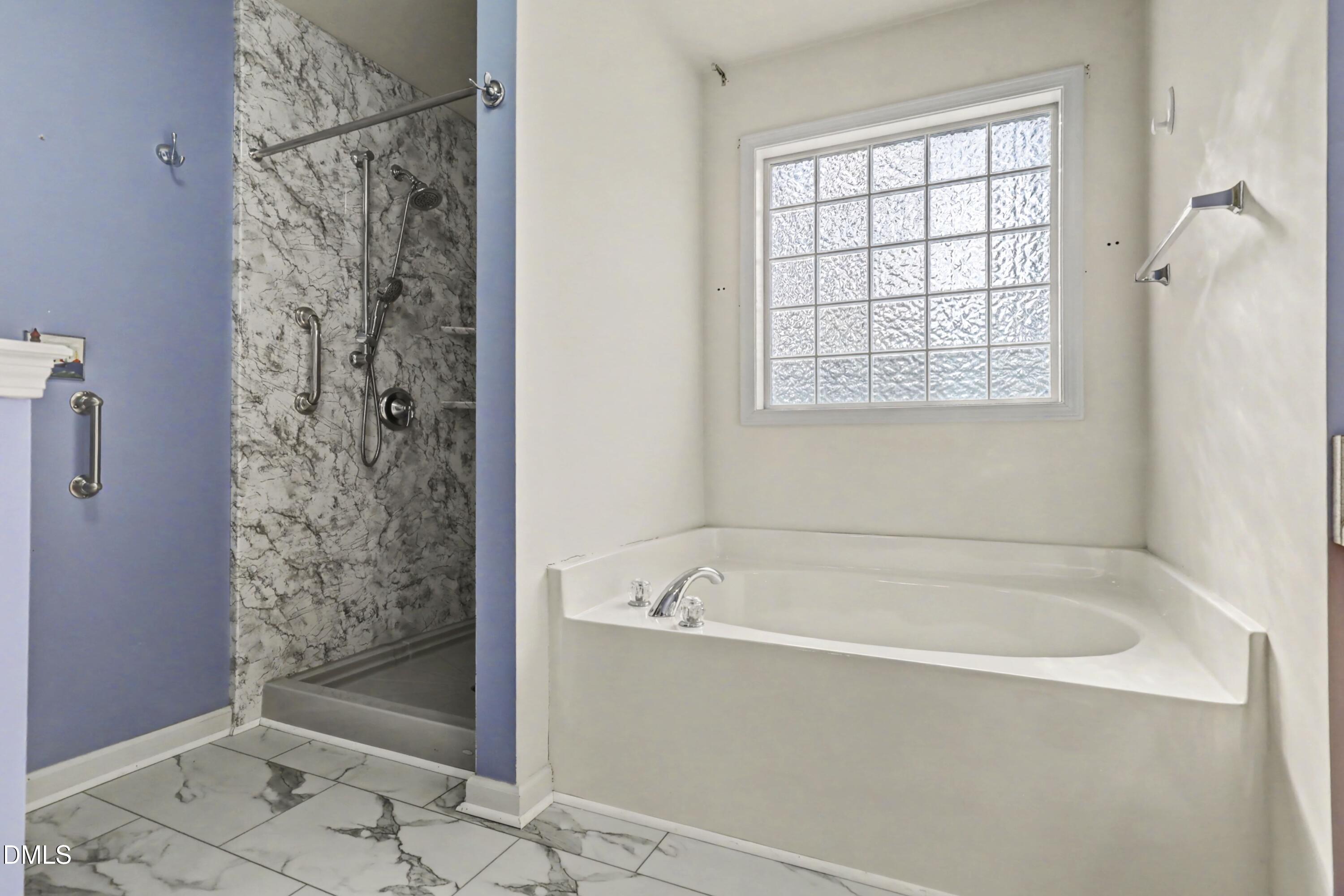 390 Eagle Stone Ridge Youngsville, NC 27596 - Photo 18 of 29 a bathroom with a bathtub and shower