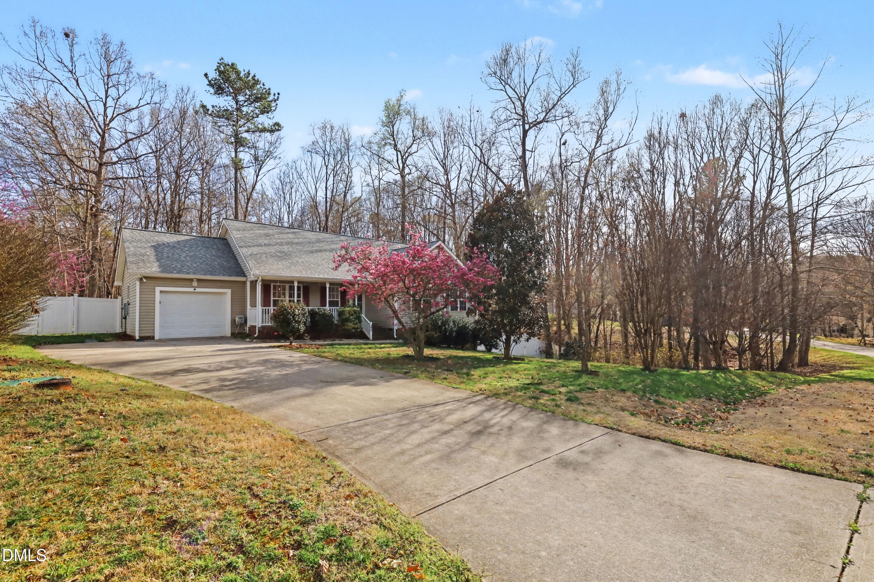 390 Eagle Stone Ridge Youngsville, NC 27596 - Photo 2 of 29 a front view of a house with a yard and a garage