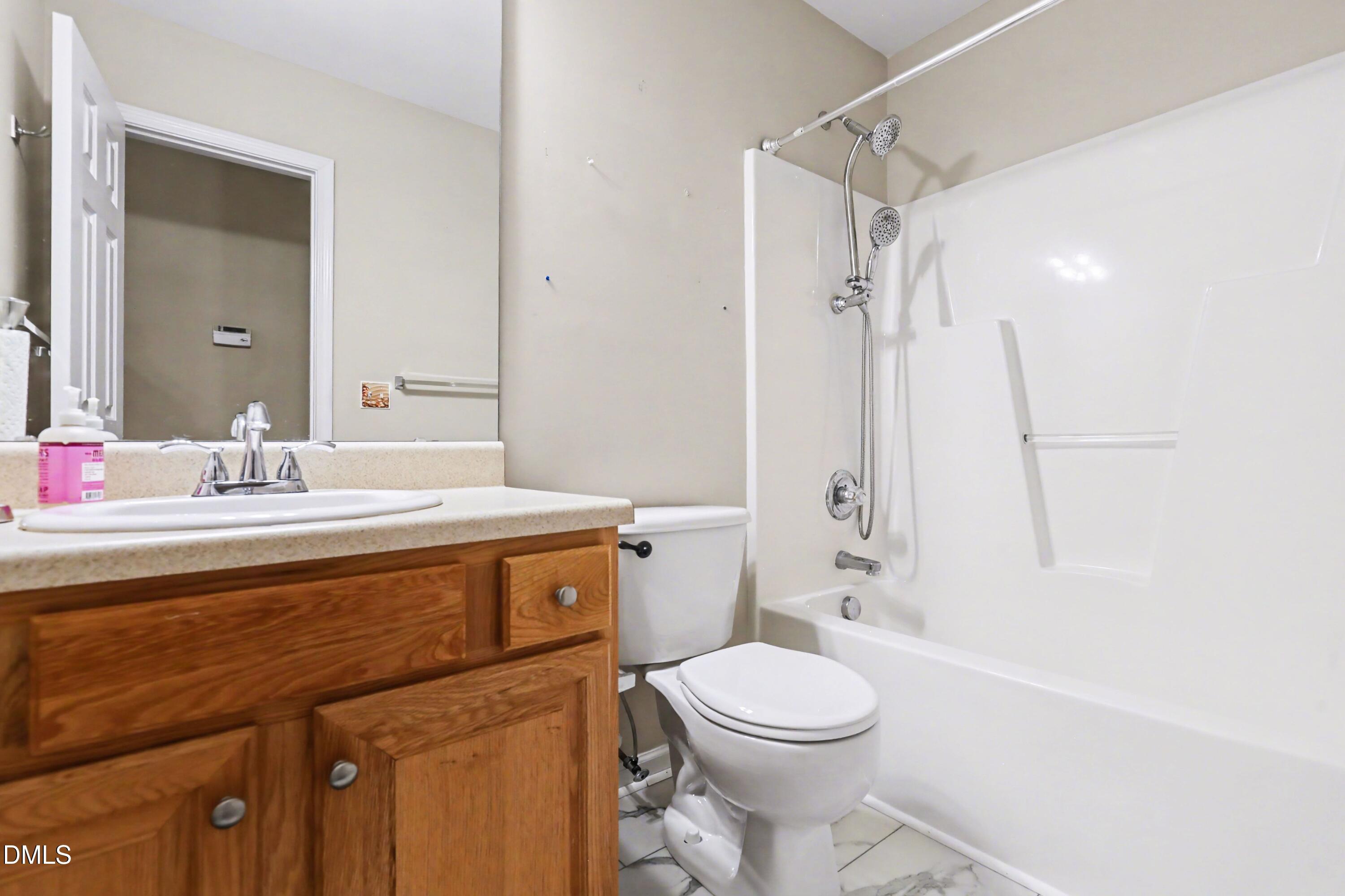 390 Eagle Stone Ridge Youngsville, NC 27596 - Photo 23 of 29 a bathroom with a sink a toilet and shower