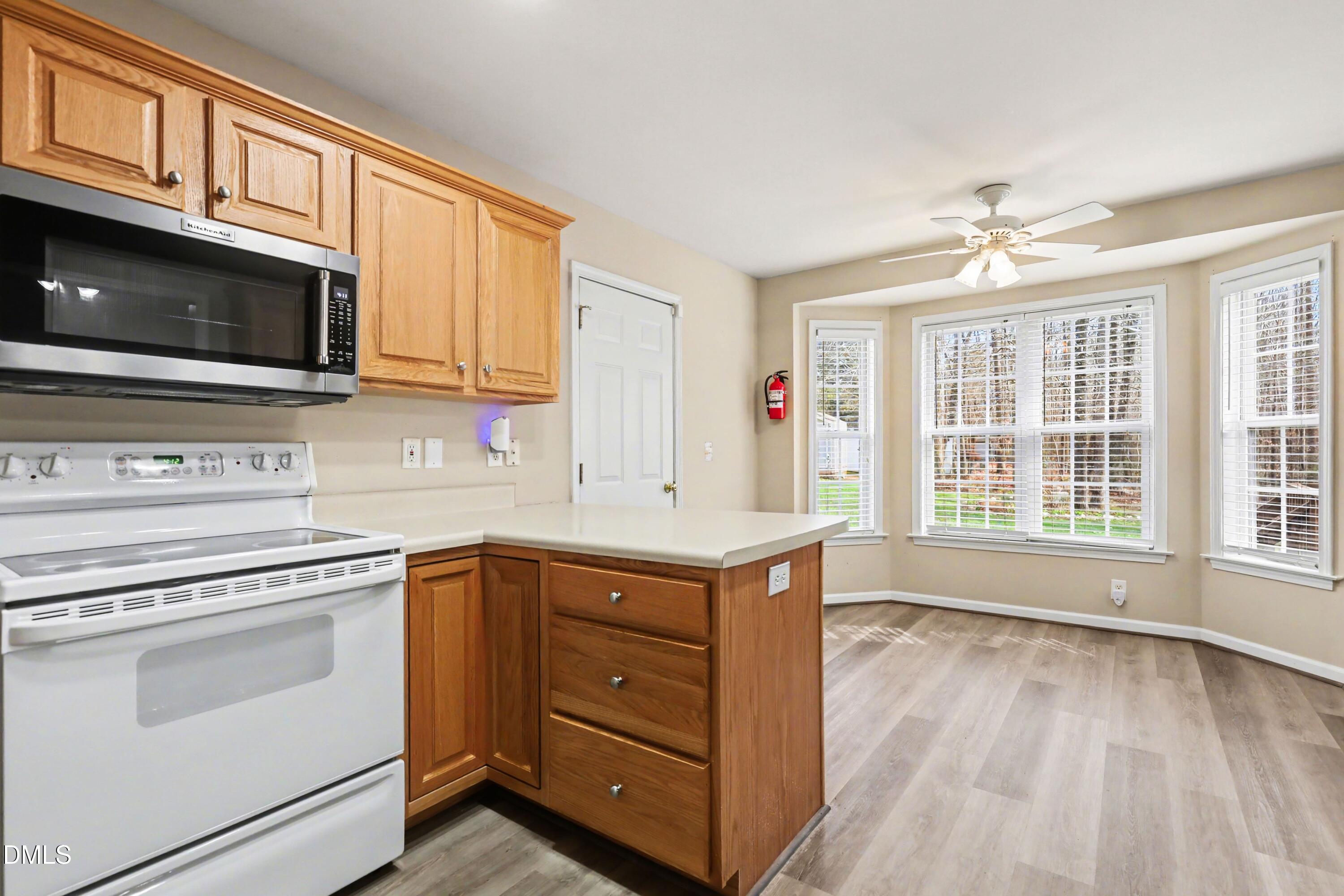390 Eagle Stone Ridge Youngsville, NC 27596 - Photo 10 of 29 a kitchen with a stove oven and a microwave