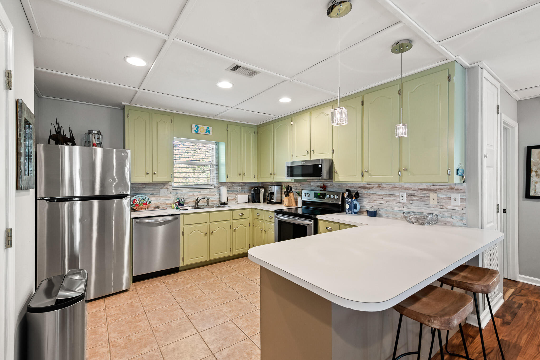 54 Sand Dunes Road Santa Rosa Beach, FL 32459 - Photo 9 of 22 a kitchen with sink a refrigerator and chairs