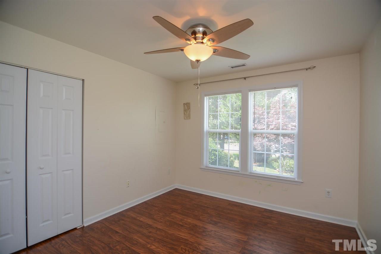 4412 Archibald Way Raleigh, NC 27616 - Photo 12 of 25 a view of an empty room with wooden floor and a window