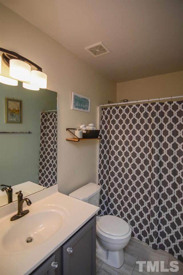 4412 Archibald Way Raleigh, NC 27616 - Photo 16 of 25 a bathroom with a sink toilet and a mirror