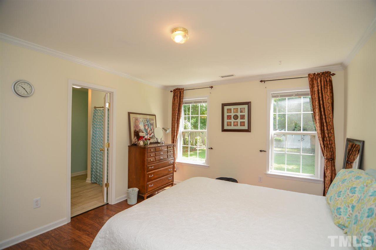 4412 Archibald Way Raleigh, NC 27616 - Photo 18 of 25 a bedroom with a bed and wooden floor