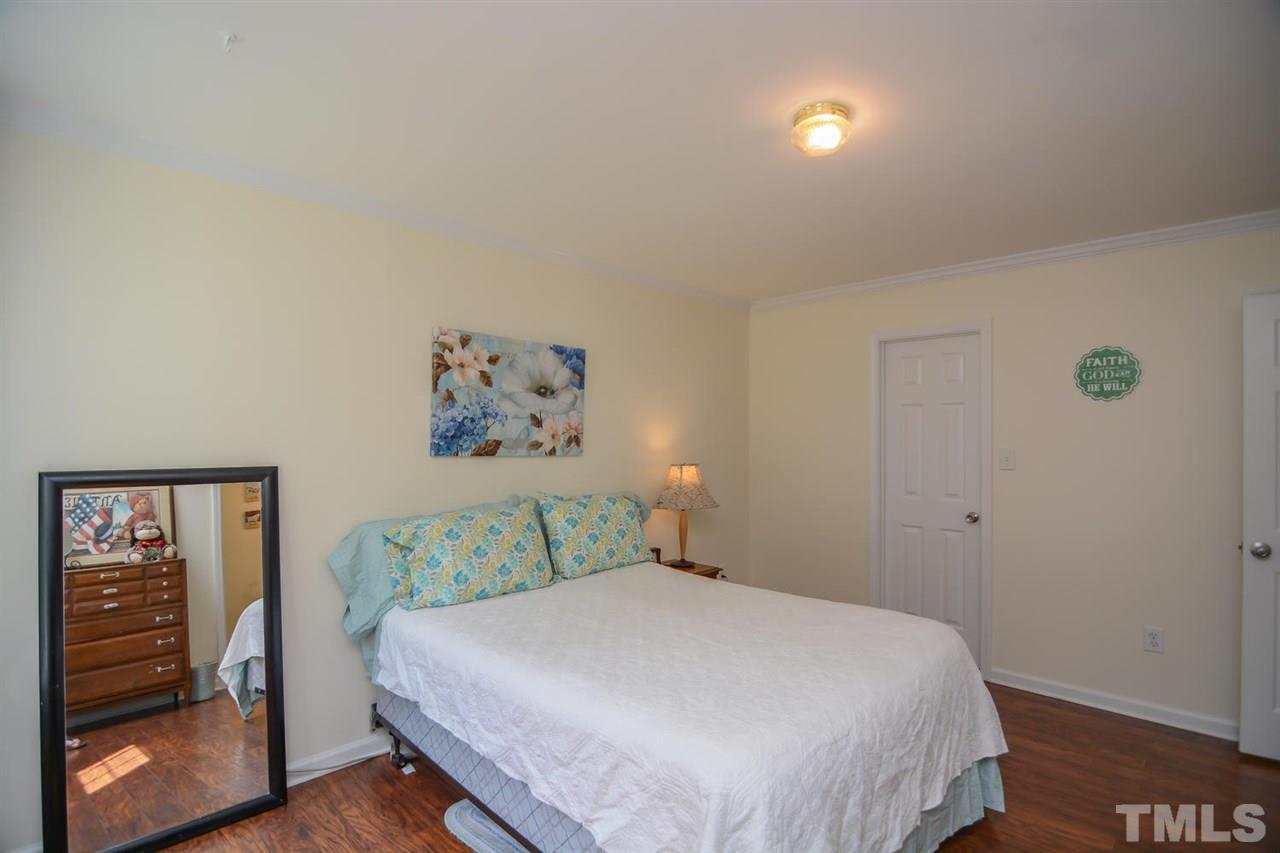 4412 Archibald Way Raleigh, NC 27616 - Photo 19 of 25 a bedroom with a bed and a window
