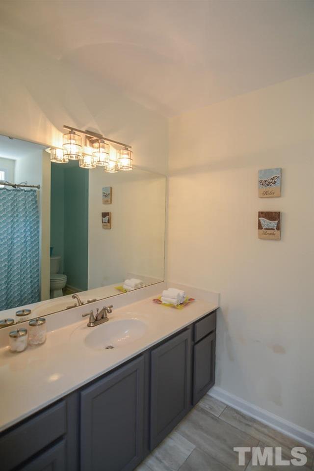 4412 Archibald Way Raleigh, NC 27616 - Photo 20 of 25 a bathroom with a sink and a mirror
