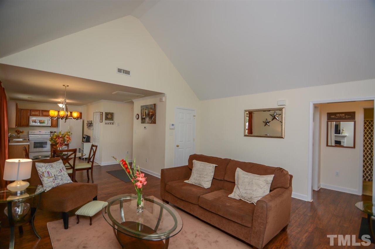 4412 Archibald Way Raleigh, NC 27616 - Photo 5 of 25 a living room with furniture a lamp and a window
