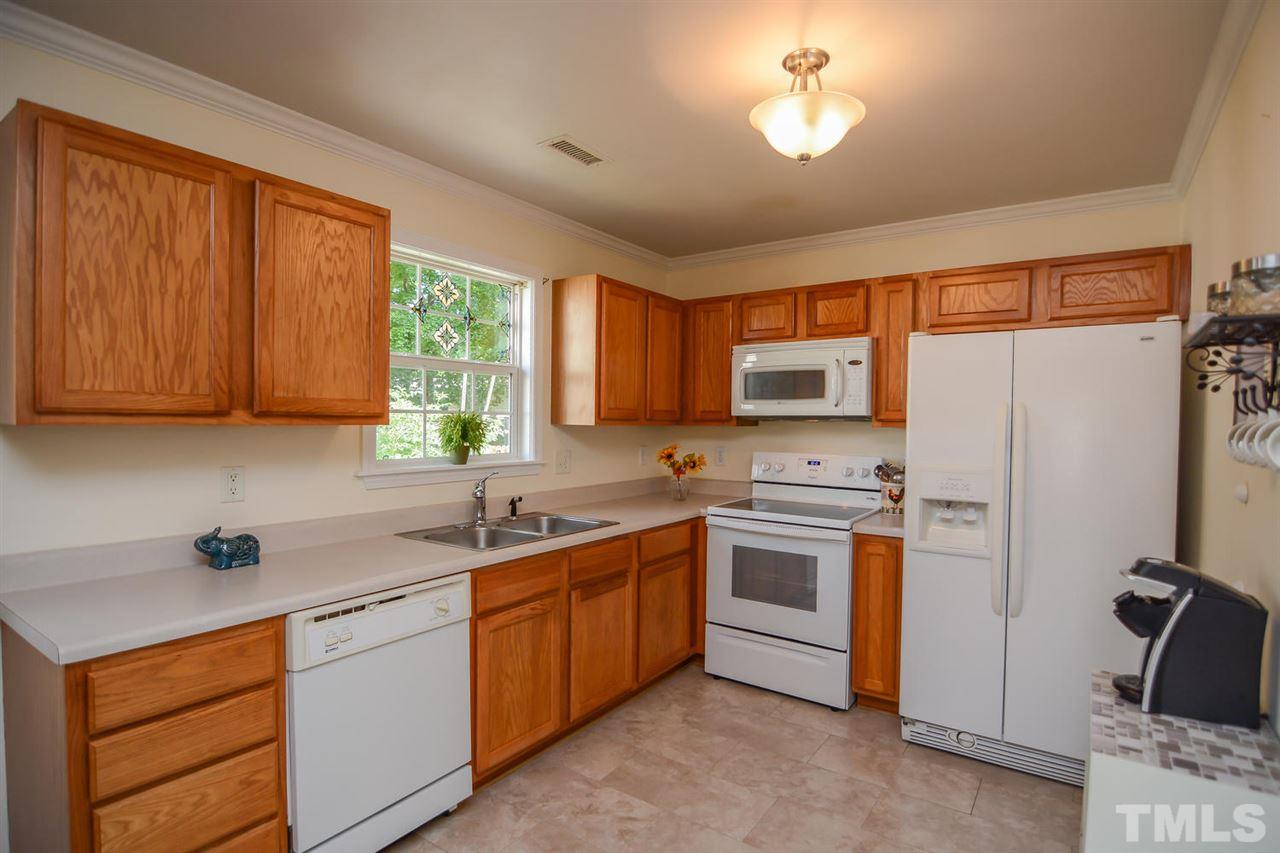 4412 Archibald Way Raleigh, NC 27616 - Photo 7 of 25 a kitchen with a sink stove and refrigerator