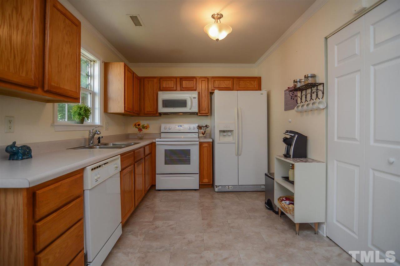4412 Archibald Way Raleigh, NC 27616 - Photo 10 of 25 a kitchen with stainless steel appliances granite countertop a stove top oven a sink and dishwasher