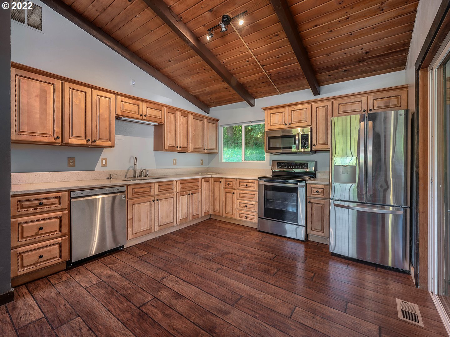 72293 Lentz Road Rainier, OR 97048 - Photo 8 of 22 a kitchen with granite countertop wooden floors stainless steel appliances and a counter space