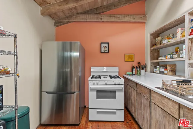 a kitchen with stainless steel appliances granite countertop a refrigerator sink and stove
