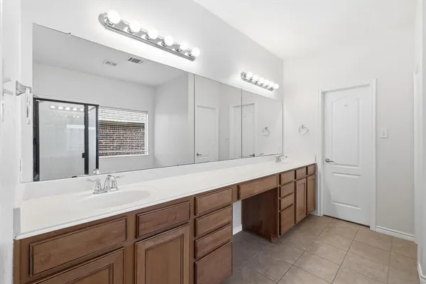 a bathroom with a sink double vanity and a mirror