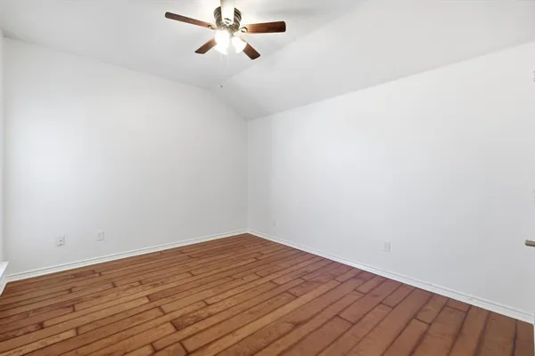 a view of a room with wooden floor