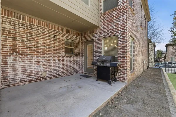 a view of a brick house with many windows