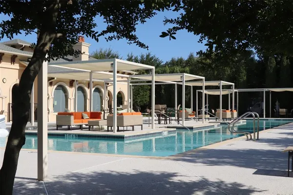 a view of a swimming pool with chairs