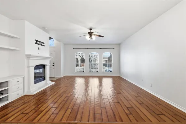 wooden floor in an empty room with a fireplace