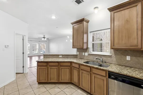a kitchen with a sink stove and cabinets