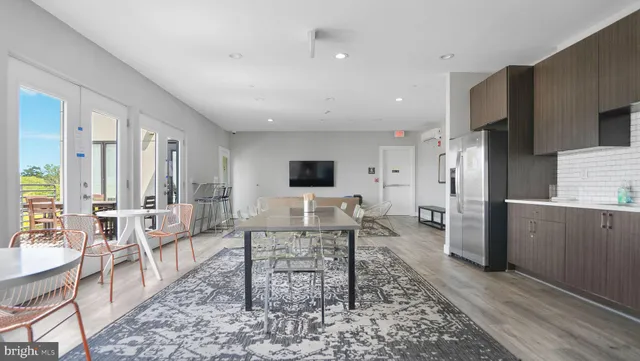 a living room with furniture wooden floor and a rug