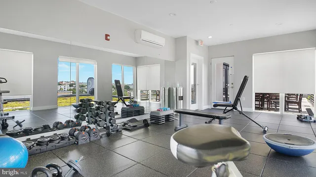 a living room with furniture a wooden floor and next to a window