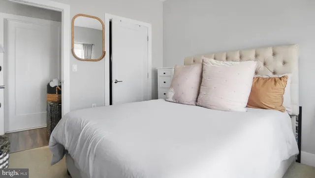 a large bed sitting in a bedroom next to a window