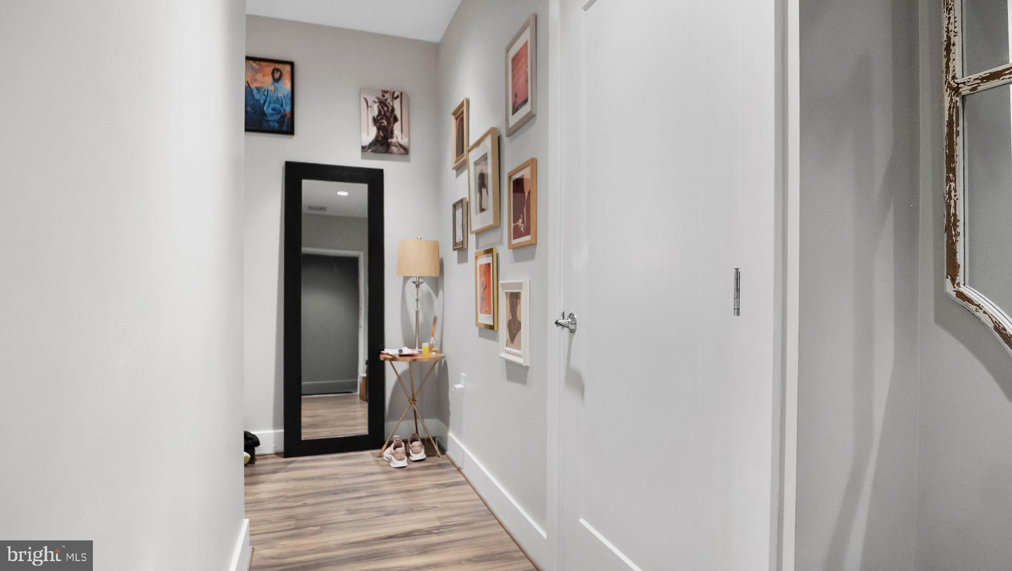 1111 Orren Street Northeast, Unit 407 Washington, DC 20002 - Photo 9 of 19 a view of a hallway with wooden floor and entryway