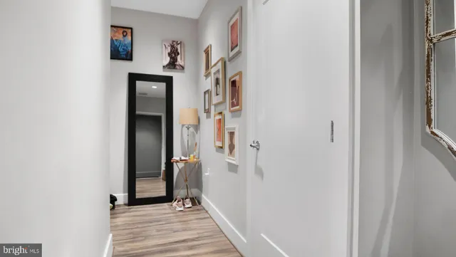 a view of a hallway with wooden floor and entryway