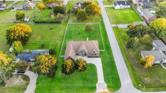 a view of a green field with house in the background