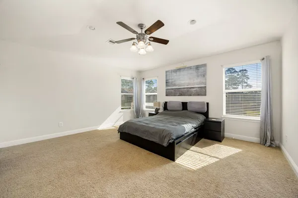 a bedroom with a bed and window