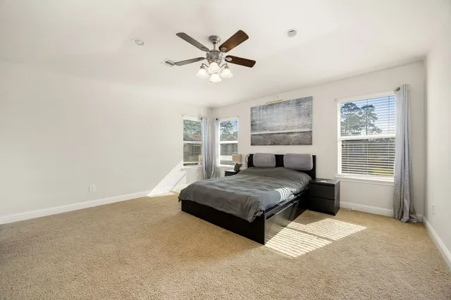 a bedroom with a bed and window