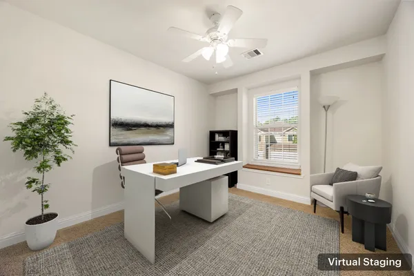 a view of a workspace with furniture and a potted plant