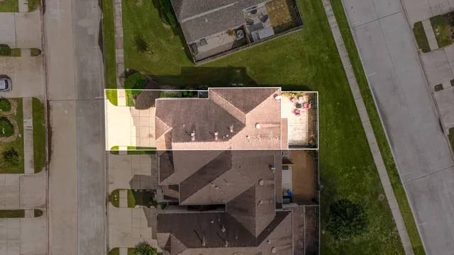 an aerial view of a house with a yard