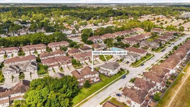 an aerial view of residential houses with outdoor space