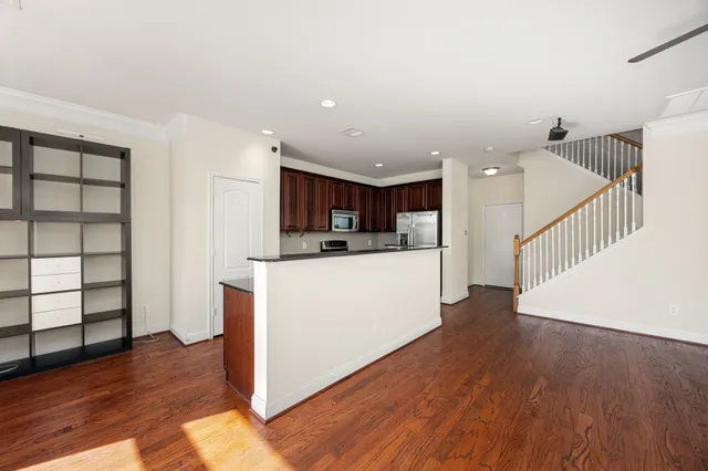 a view of kitchen with wooden floor and electronic appliances