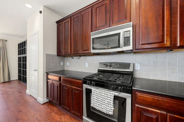 a kitchen with wooden cabinets and a stove top oven