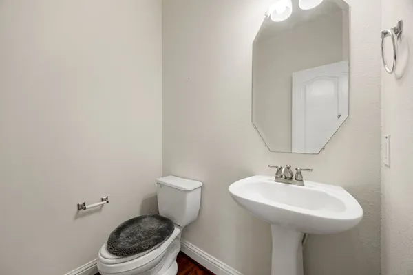 a bathroom with a sink a toilet and a mirror