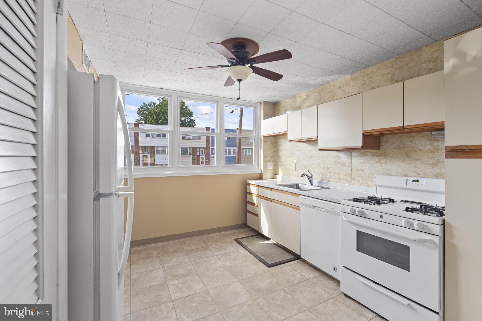 4274 Lawnside Road Philadelphia, PA 19154 - Photo 6 of 20 a kitchen with stainless steel appliances a white stove top oven and cabinets