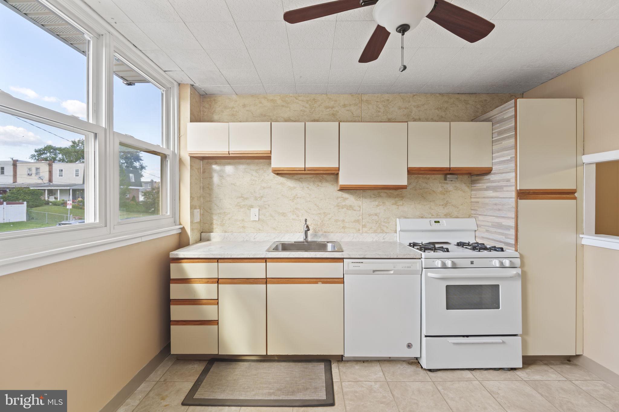 4274 Lawnside Road Philadelphia, PA 19154 - Photo 7 of 20 a kitchen with a stove and a white cabinet