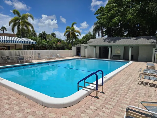a view of a swimming pool with potted plants
